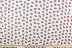 This chiffon fabric features a heart design with a leopard design in taupe and red against a white background. 
