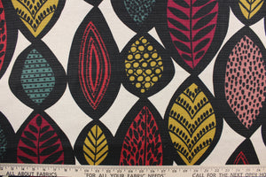 This fabric features a large leaf design in black, deep red, mustard yellow, rose pink and deep teal against a natural background.