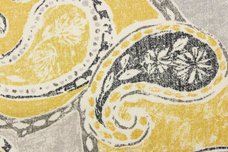 This fabric features a paisley design in yellow, gray, black, and off white.