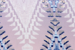  This georgette fabric features a Aztec design in shades of blue, pink, gray, white, pale purple, and pale yellow.