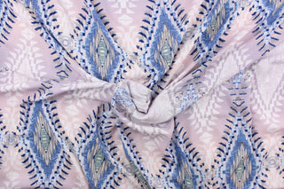  This georgette fabric features a Aztec design in shades of blue, pink, gray, white, pale purple, and pale yellow.