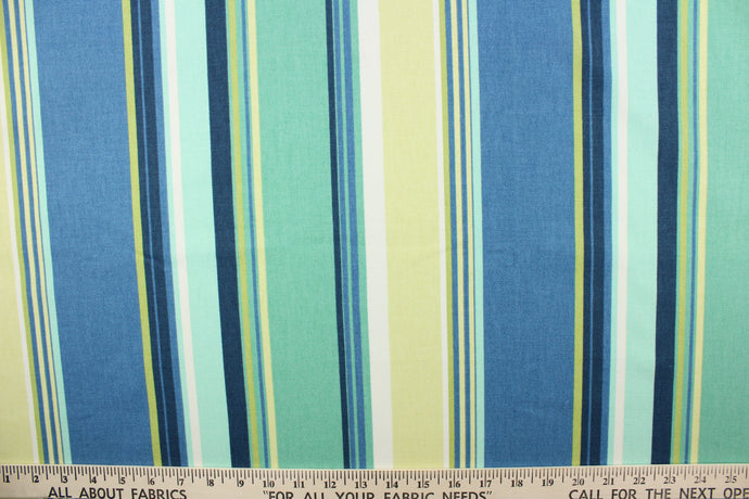 This outdoor fabric features a stripe design in blue, lime green, turquoise, white, and pale yellow