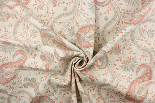 This fabric features a paisley vine design in cream. gray, taupe, and coral pink with hints of light beige. 