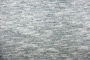  This chenille fabric features a unique design in gray, silver, blue, teal, blue green, and white.
