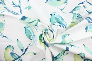 This fabric features a bird design in varying shades of turquoise, lime green, blue and white. 