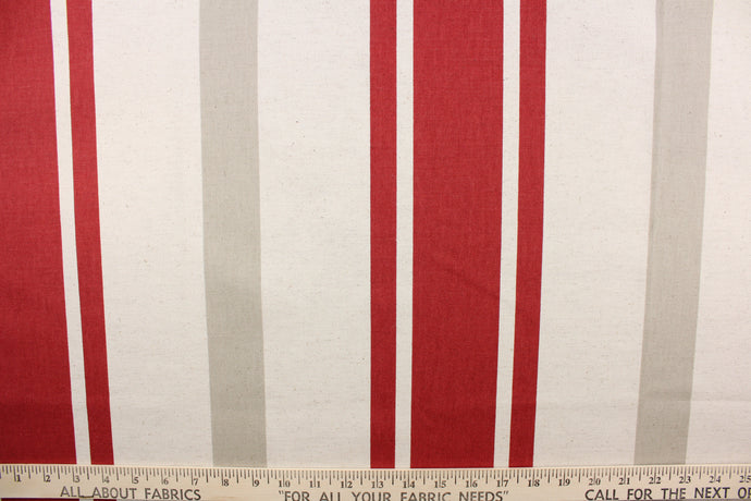 This fabric features a stripe design in red, beige, and off white. 