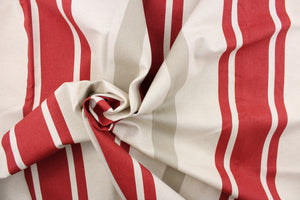 This fabric features a stripe design in red, beige, and off white. 