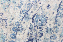 Load image into Gallery viewer, This fabric features a paisley design in varying shades of blue with some gray undertones against a off white.
