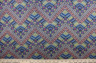 This jersey fabric features a Aztec geometric design in orange, neon yellow, black, hot pink and blue.