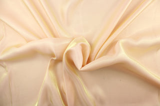 This taffeta fabric in iridescent in a pale orange. 