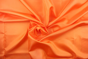 This taffeta fabric in solid bright orange
