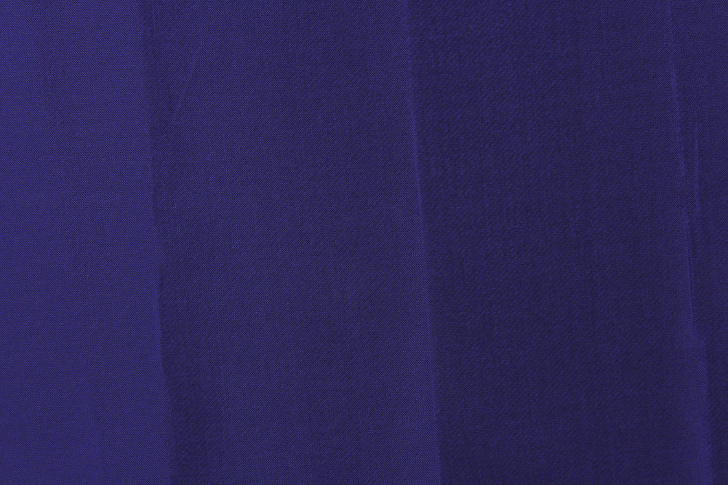This taffeta fabric in iridescent in purple with undertones of black