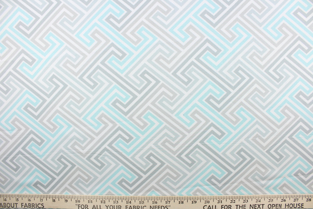 This fabric features a geometric design in gray, white and pale turquoise. 