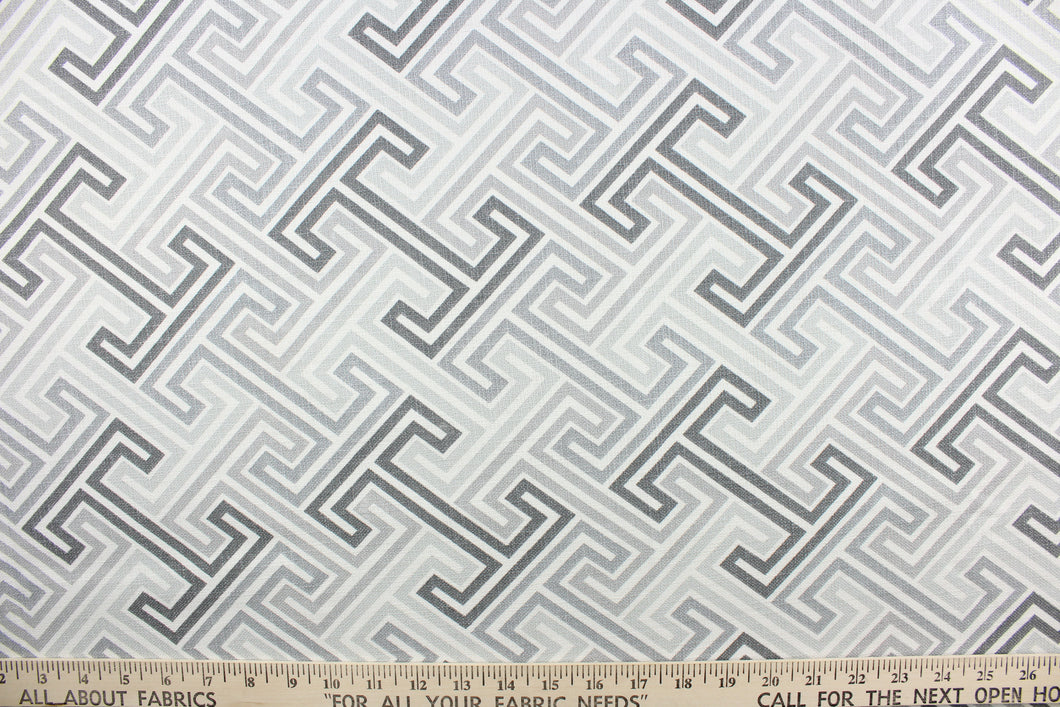This fabric features a geometric design in varying gray tones and white
