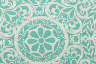 This fabric features a medallion design in turquoise and white. 