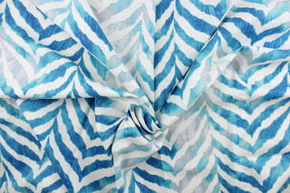 This fabric features a chevron zebra stripe design in turquoise, gray, white, and blue.