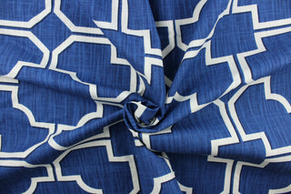 This fabric features a geometric design in white with black outline against a blue background.