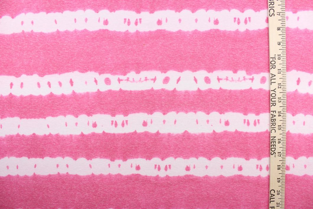 This jersey fabric features a stripe design in pink and white.