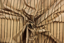 Load image into Gallery viewer, This stunning yarn dyed fabric features a  striped pattern in old gold and green. Enhancing the various colors of the stripes is a slight sheen.
