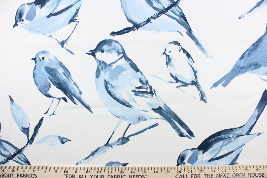  This fabric features a bird design in varying shades of blue against a white background