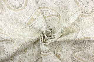 This fabric features a beautiful paisley design in beige, taupe, gray, and white.