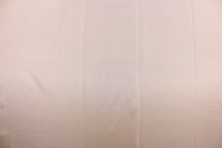 This taffeta fabric in solid light peachy pink .