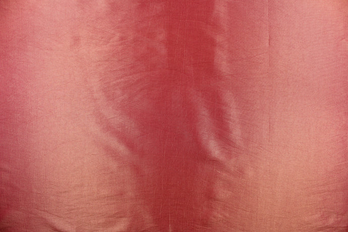 This taffeta fabric in iridescent pink red with gold undertones.