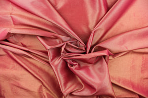 This taffeta fabric in iridescent pink red with gold undertones.