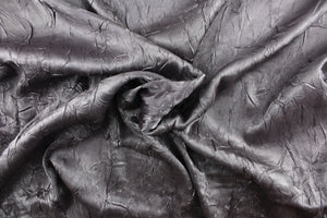This taffeta fabric features a crinkle in iridescent silver gray.