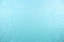 Load image into Gallery viewer, This taffeta fabric features a crinkle in iridescent in a light turquoise blue.
