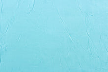Load image into Gallery viewer, This taffeta fabric features a crinkle in iridescent in a light turquoise blue.
