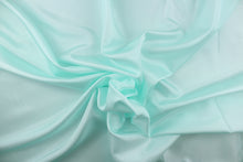 Load image into Gallery viewer, This taffeta fabric in solid pale seafoam blue . 
