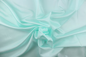 This taffeta fabric in solid pale seafoam blue . 