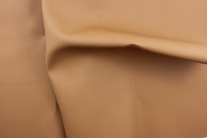 This vinyl fabric features a smooth design in a rich tan.