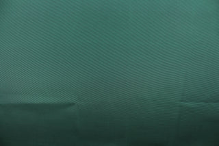 This bengaline faille fabric in a solid dark green. This fabric has a slight shine and a slight ribs in the weft. 