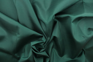 This bengaline faille fabric in a solid dark green. This fabric has a slight shine and a slight ribs in the weft. 