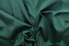 Load image into Gallery viewer, This bengaline faille fabric in a solid dark green. This fabric has a slight shine and a slight ribs in the weft. 
