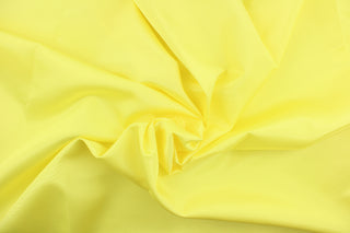 This bengaline faille fabric in a solid bright yellow. This fabric has a slight shine and a slight ribs in the weft. 