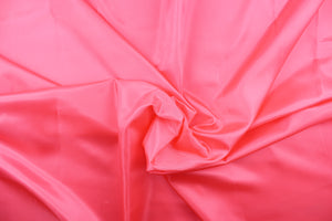 This taffeta fabric in solid bright pink . 