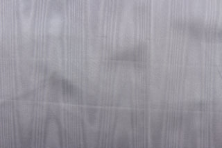 This taffeta fabric in a solid gray. This fabric has a slight shine and a wavy, watery look