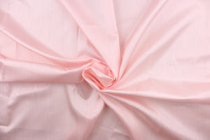 This taffeta fabric in a solid pink. This fabric has a slight shine and a wavy, watery look.