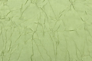  This taffeta fabric features a crinkle in iridescent apple green. 