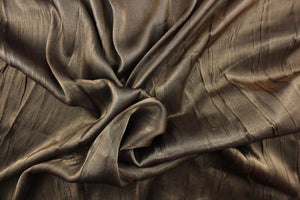 This taffeta fabric features a crinkle in iridescent old gold.