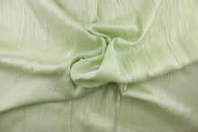 Load image into Gallery viewer, This taffeta fabric features a crinkle in iridescent pale green. 
