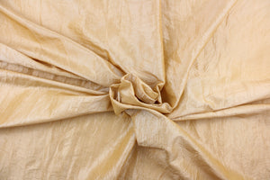 This taffeta fabric features a crinkle in iridescent light gold.