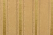 Load image into Gallery viewer, This stunning yarn dyed fabric features a striped pattern in varying shades of gold. Enhancing the various colors of the stripes is a slight sheen.
