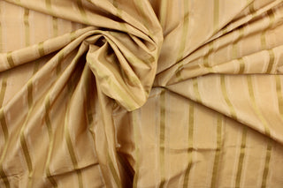 This stunning yarn dyed fabric features a striped pattern in varying shades of gold. Enhancing the various colors of the stripes is a slight sheen.