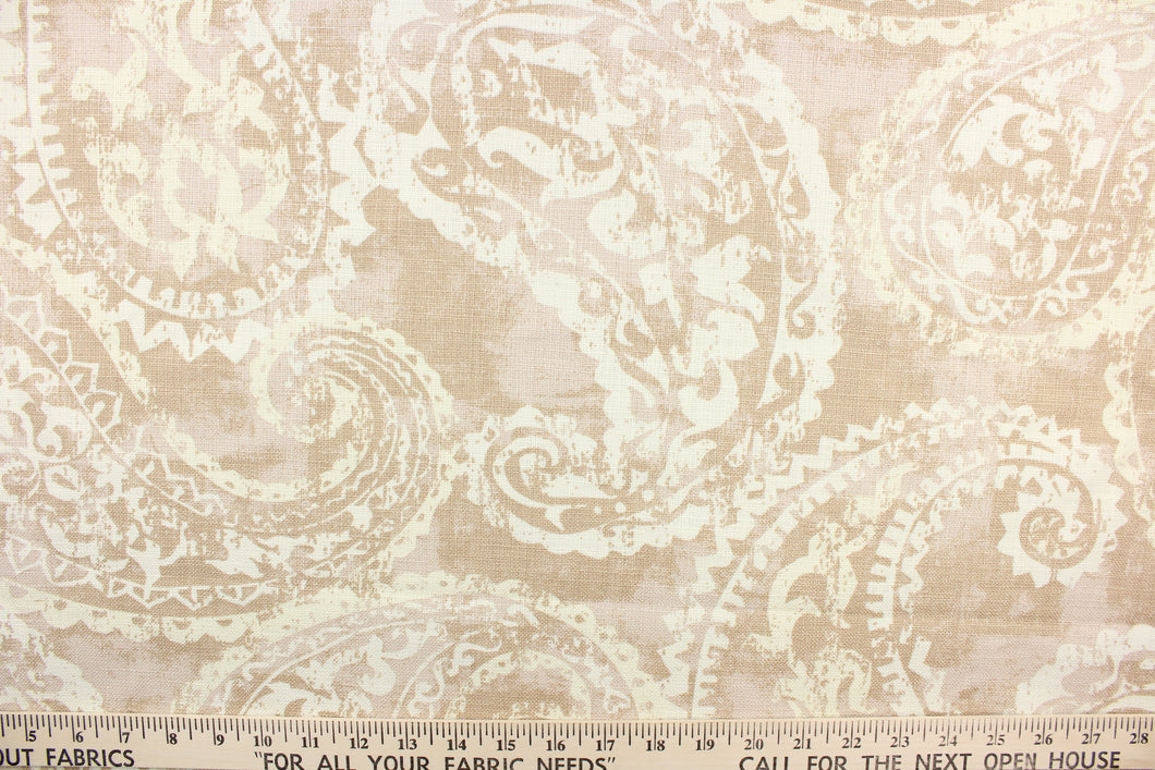  This fabric features a paisley design in beige and white.