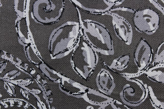 This fabric features a leaf design in gray and black against a dark gray background .