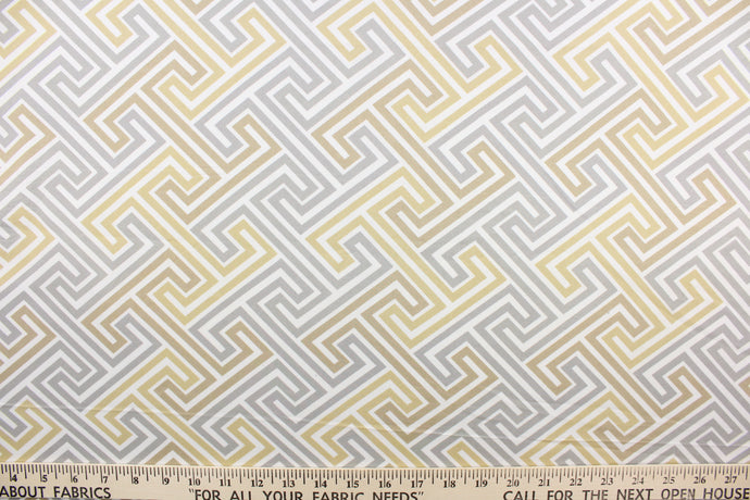 This fabric features a geometric design in  beige, khaki gray and white.